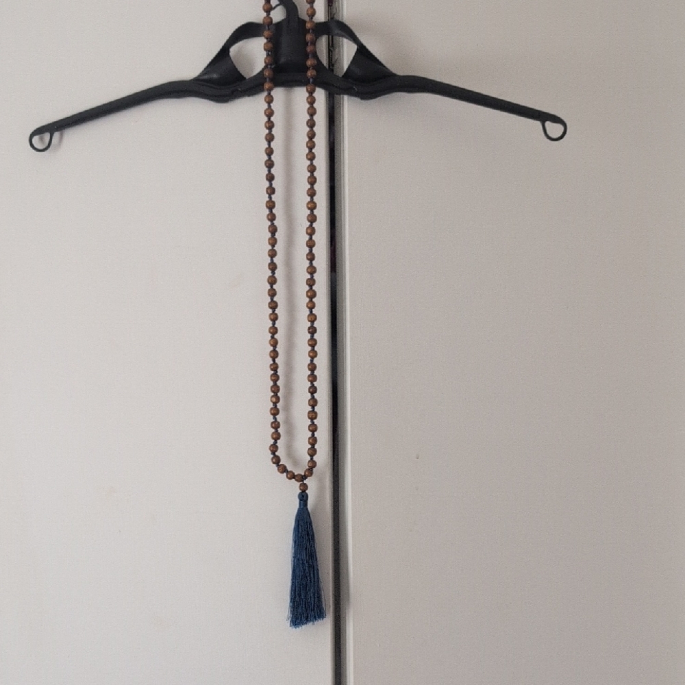 Elegant Brown Beaded Necklace with Blue Tassel